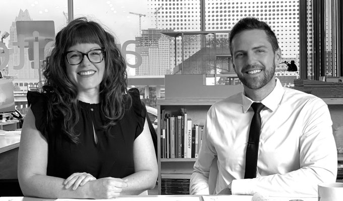 Architects Sarah Johnson and Matt Fajkus sitting at a table with blueprints.