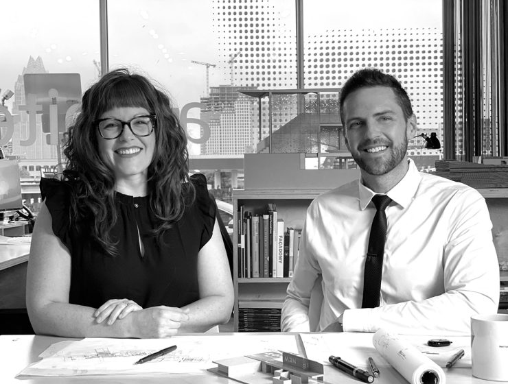 Architects Sarah Johnson and Matt Fajkus sitting at a table with blueprints.